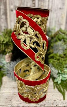 a red and gold ribbon on top of a wooden table