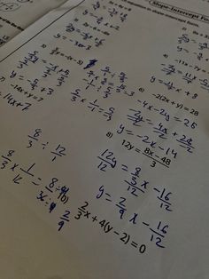 a piece of paper that has some writing on it with numbers and letters written in blue ink