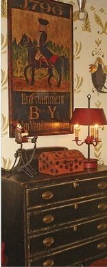 an old dresser has a lamp on it and a painting above it that says, entertainment by vanity