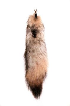 a furry animal tail hanging from a hook