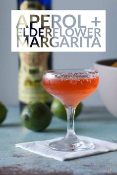 an image of a drink in a glass with the words aperol + elderflower margarita