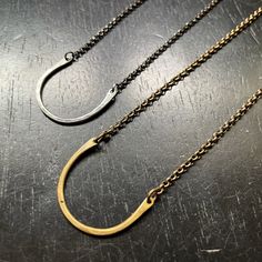 This simple necklace resembles a horse shoe and serves as a ring holder. I had a request from a massage therapist, she wanted a necklace that she could hang her wedding ring from so she could have her hands free. Great on it's own or with long layers! (RING IN PHOTO NOT INCLUDED) 1" wide, 16" sterling/ brass chain Available in 2 metals:- Silver - Brass Minimalist Jewelry With Adjustable Chain For Everyday, Elegant Horseshoe Necklace For Everyday, Horseshoe Necklace With Adjustable Chain As Gift, Horseshoe Necklace With Adjustable Chain For Gift, Simple Hand Forged Jewelry As Gift, Simple Hand Forged Jewelry For Gifts, Minimalist Hand Forged Oval Jewelry, Simple Hand Forged Jewelry For Gift, Elegant Handmade Jewelry For Everyday Use