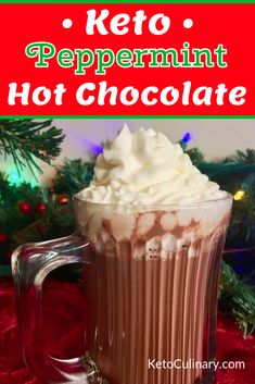 a hot chocolate drink with whipped cream in a glass mug on a red tablecloth