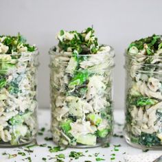 four glass jars filled with food on top of a table