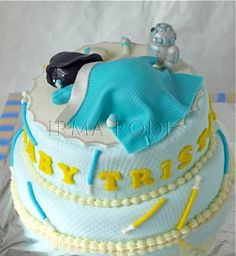 a blue and white cake with an elephant on top