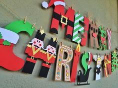 the letters are made out of paper and decorated with christmas decorations, such as santa's stocking