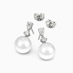 A stunning showcase of elegance and refinement, these drop earrings delight at first glimpse. Each earring features a lustrous pearl suspended with soft grace beneath a pear and round gemstone. The elegant design sways gently with your movements, gleaming subtly to draw admiring eyes. Whether worn for day or evening, the understated luxury of these drops enhances any outfit with impeccable taste and sophistication. *Each piece is handmade, resulting in a potential variance of 0.1-0.2mm during me Elegant Akoya Pearl Drop Earrings, Elegant White Drop Pearl Earrings, Elegant White Gold Drop Pearl Earrings, Elegant Diamond Pearl Earrings, Elegant Drop Pearl Earrings For Anniversary, Elegant Diamond Bridal Earrings With Pearl Drop, Elegant Pear-shaped Pearl Earrings, Elegant Pear-shaped Diamond Pearl Earrings, Elegant Pear-shaped Bridal Earrings For Formal Occasions