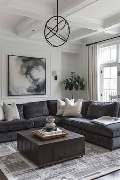 a living room filled with furniture and a large painting hanging on the wall above it