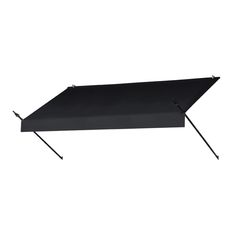 a black awning on top of a white wall with two poles attached to it