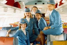 a group of people that are sitting on a bench in the back of a plane