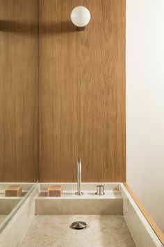 a bathroom with a sink and wooden walls