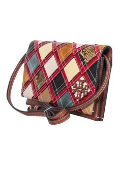 Fashion meets function with the Tory Burch McGraw Patchwork Wallet Crossbody. Boasting a colorful patchwork design and signature logo appliqué, this leather wallet offers a well-organized interior and optional crossbody strap. Plus, a removable zip pouch with built-in card slots adds to the everyday practicality of this stylish statement accessory. Leather Flap closure Removable & adjustable crossbody strap Exterior slip pocket Dual interior compartments Eight card slots Width 8.75" Height 5.25" Depth 1.5" Strap drop 22" - 25" Multicolor Bifold Bags For Everyday Use, Multicolor Bifold Travel Bag, Multicolor Bifold Bags With Card Slots, Designer Quilted Leather Wallet, Designer Leather Wallet With Quilted Detail, Designer Quilted Rectangular Wallet, Multicolor Leather Wallet For Everyday Use, Multicolor Leather Wallets For Everyday Use, Multicolor Leather Bag With Interior Card Slots