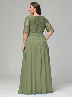 a woman in a long green dress with lace on the top and sleeves, looking back