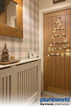 a christmas tree is hanging on the wall next to a radiator in a bathroom