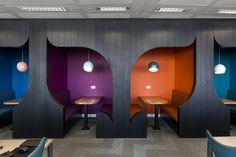 the interior of a restaurant with colorful booths