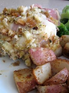 a white plate topped with potatoes and meat next to broccoli