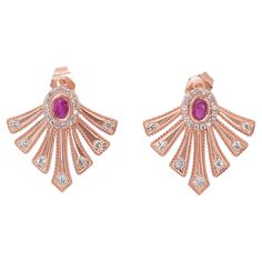 These elegant earrings feature 2 oval rubies totaling 0.55 carats, graded red color with N/A clarity, complemented by 48 round brilliant diamonds totaling 0.2 carats, with E-F color and VS1-SI1 clarity. The total carat weight is 0.75ct, and the earrings have a total jewelry weight of 5.01g, offering a stunning balance of vibrant color and brilliant sparkle. Metal: 14K Rose Gold Main stone: 2 Stones Ruby Main stone carat weight: 0.55ct Shape: Oval Color grade: Red Clarity grade: N/A Side stone: 4 Oval Red Diamond Earrings For Anniversary, Oval Red Ruby Earrings, Red Oval Art Deco Jewelry, Red Oval Ruby Earrings, Luxury Oval Ruby Earrings, Bear Face Drawing, Rose Gold Stud Earrings, Rubies And Diamonds, Rose Gold Earrings Studs