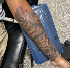 a man with a snake tattoo on his arm