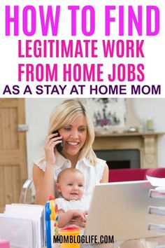 a woman sitting at her desk with a laptop and talking on the phone while holding a baby