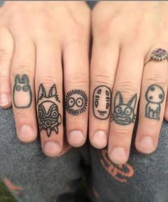 two fingers with different tattoos on them