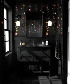 a black and white bathroom with floral wallpaper on the walls, sink and mirror