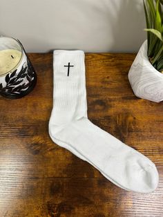 Cross embroidered Crew pair of Socks. Black Cross with White sock. One pair of socks with one cross on each sock. Left on one and right on other. Size: Men 6-12 Women 5-9 Family made faith apparel to get the conversation started!  check out more of our listings: https://praiseourgodapparel.etsy.com Custom Thread: Optional to Personalized  with your own color, options in photos.  Crew socks are made to order. Please ask any questions before purchase. Please allow for slight color variation in pro White Cotton Socks For Gifts, White Cotton Socks As Gift, White Cotton Socks As A Gift, Christian Socks, Embroidery Socks, Faith Apparel, Christian Merch, Cross Embroidery, Personalized Socks