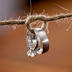 two wedding rings hanging from a rope