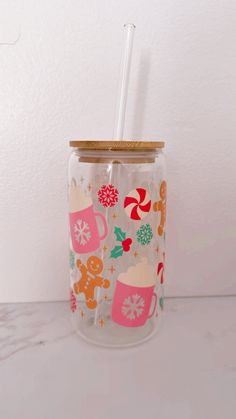 a glass with a straw in it sitting on a counter next to a white wall