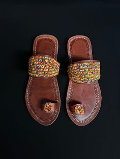 Unique Africa Maasai Handcrafted Beaded Leather Sandals with an Elegant Look and Brilliant Finish. Color =Multi Color. Size = Optional. **GET FREE SHIPPING FOR ADDITIONAL ITEMS PURCHASED. Yes, Buy Multiple Items and pay shipping for 1 item only- The rest ships Free. (No Limits on the number of Multiple items). With a faster delivery time of 3 days via DHLExpress, Worldwide. Ordinary/Standard Shipping also available upon request. We Custom Make to Suit Your Taste. Available In All Colors and Size Traditional Beaded Brown Flip Flops, Traditional Brown Beaded Flip Flops, Traditional Handmade Brown Flip Flops, Handmade Adjustable Slip-on Sandals, Traditional Open Toe Flip Flops For Festivals, Traditional Open Toe Brown Flip Flops, Traditional Brown Open Toe Flip Flops, Traditional Brown Beaded Sandals, Handmade Multicolor Slip-on Sandals