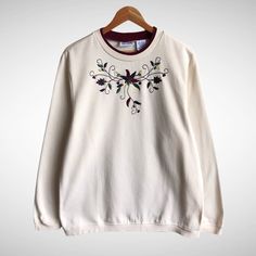 "CODE : 107 Vintage Blair Flower Cream Sweatshirt Size Large Flower Crewneck Flower Sweater Pullover Embroidered Logo Flower Shirt Jumper Size on Tag : L Details Measurement  Arm Pit to Arm Pit : 23\"inches Back Collar to Hem : 28\"inches Condition :  Great Vintage Condition..❌NO HOLES AND NO STAIN❌Please refer pictures detail.‼️ 📮 SHIPING > WE ARE USING DHL EXPRESS SHIPING ITS TAKE 3-5 ARRIVE.PLEASE DROP YOUR PHONE NUMBER AFTER PURCHASE.📮" Fall Floral Applique Crew Neck Sweater, White Sweater With Floral Embroidery And Crew Neck, White Crew Neck Sweater With Floral Embroidery, Cream Floral Print Crew Neck Top, Cream Crew Neck Sweater With Floral Embroidery, Cream Crew Neck Top With Floral Embroidery, Cream Floral Embroidered Crew Neck Sweater, White Floral Embroidered Sweatshirt For Fall, Cream Crewneck