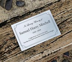 a close up of a wooden bench with a business card on it