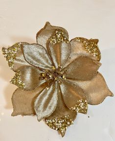 a golden flower with gold sequins on it