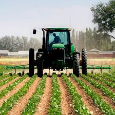 a tractor is plowing the field in the rain