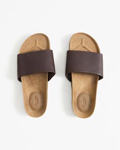 Comfortable and durable slide sandals in a soft leather fabric featuring a cork sole with embossed logo detail. Male Features, Brown Sandals, Athletic Fits, Mens Swimwear, Embossed Logo, Leather Fabric, High Quality Leather, Slide Sandals, Size 13