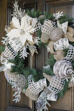 a wreath with burlocks and snowflakes hanging on the front door for christmas