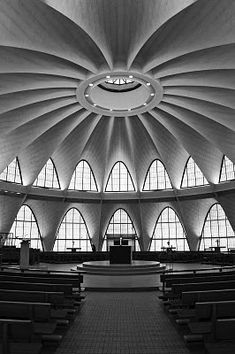 the inside of a church with large windows