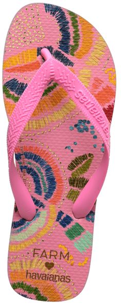 a pair of pink flip flops with colorful flowers on the bottom and an open toe