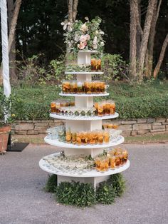 a three tiered cake with flowers and candles on the top is featured in an instagram