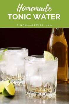 homemade tonic water with limes and lemon wedges on the rim in front of two glasses