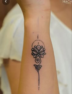 a woman's arm with a flower tattoo on it