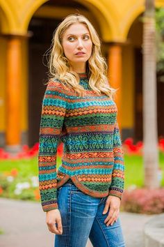 a woman standing in front of a building with her hands on her hips and looking at the camera