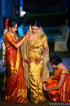 two women in yellow and orange sari are getting ready to go on their wedding day