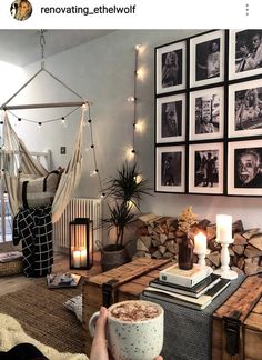 a living room filled with furniture and pictures hanging on the wall next to a fire place