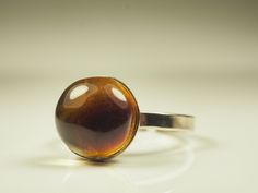 Natural Glossy Cognac color Genuine Baltic Amber Adjustable ring 2.9 grams. Handmade ring. Amber measurements: 11x11x8 mm. Metal: Melchior.  Size: Adjustable Weight: 2.9 grams. Shipping: Shipping is free. Delivery will be done immediately after payment received. I send items worldwide by Registered Priority Air Mail. Delivery from Lithuania takes about 7-14 business days. RETURN POLICY: Returns are accepted. Before sending the item back, always contact us. 14 days of delivery day. Delivery shipp Brown Rings With Polished Finish For Gift, Brown Ring With Polished Finish For Gift, Brown Polished Finish Ring As Gift, Handmade Brown Rings For Formal Occasions, Adjustable Cabochon Rings For Formal Occasions, Adjustable Dome Ring For Formal Occasions, Formal Brown Handmade Rings, Adjustable Cabochon Ring For Formal Occasions, Adjustable Oval Rings In Brown