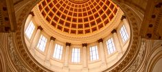 the inside of a large building with a dome and two windows on each side of it