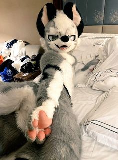 a stuffed animal that is laying down on a bed