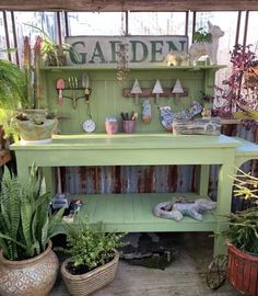 a green bench with potted plants on it in a garden shop or yard area