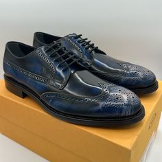 A Traditional Wingtip Leather Derby Gets A Modern Upgrade With A Faded Vintage Blue Finish. Finished With Tod's Signature Nubbed Sole For Stabilty, This Stunning Shoe Is Sure To Be A Workwear Favorite. Leather Upper, Leather And Synthetic Sole Lace-Up Vamp Closure Made In Italy Size 9.5 Uk - According To Tod’s This Will Fit An 11 Us Men’s Includes Box, Dust Bag, And Care Card (Box Is Damaged Because Nordstrom Shipped Them To Me In A Bag Instead Of A Box) Blue Wingtip Leather Shoes For Work, Designer Leather Shoes With Brogue Detailing For Derby, Blue Brogue Dress Shoes For Business Casual, Designer Dress Shoes With Brogue Detailing For Derby, Blue Dress Shoes With Brogue Detailing For Business Casual, Designer Wingtip Leather Shoes With Brogue Detailing, Designer Goodyear Welted Wingtip Dress Shoes, Blue Wingtip Leather Shoes For Business Casual, Designer Wingtip Dress Shoes For Derby