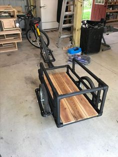 three bikes parked in a garage with wooden boards on the back and wheels attached to them