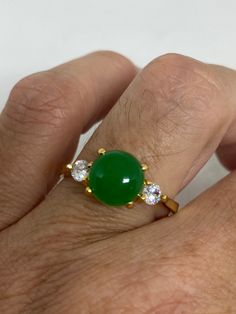 Vintage Lucky Green Nephrite Jade ring Fun jade is color enhanced Large green nephrite jade Ornate German Gold finished Vintage ring, does not tarnish, NOT sterling Size 5.5, 7, 8 or 8.5 All rings are shipped free in the US in a nice gift box. Check out our over a THOUSAND great reviews Engraving is $4 per letter and is not always perfect depending on the piece. It can take a few days if the jeweler is busy. This is payable to Paypal Judithsltd@gmail.com Green Cabochon Round Stone Rings, Green Emerald Crystal Ring, Green Jade Round Stone Jewelry, Green Jade Jewelry With Round Stone, Green Crystal Gemstone Ring, Green Crystal Gemstone Ring For Spiritual Wear, Green Gemstone Crystal Ring, Jade Gemstone Ring With Round Stone, Jade Gemstone Rings For Healing